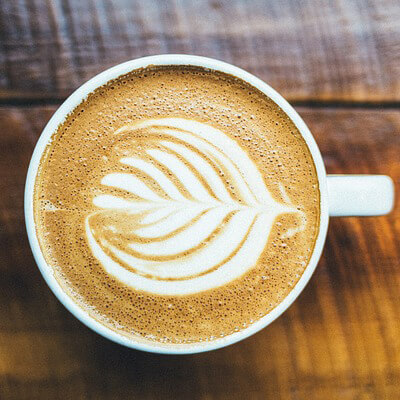 Decorative foam on that perfect cup of coffee made using the right coffee processing equipment